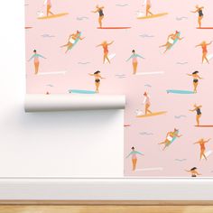 a pink wallpaper with surfers on it and a surfboard in the background