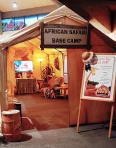 an african safari base camp is set up in the middle of a room with a sign