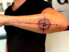 a person with a tattoo on their arm that has a compass and words written in it