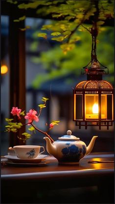 a teapot and cup on a table next to a lamp