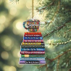 a christmas ornament hanging from a pine tree filled with children's books