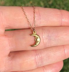 Smiling moon necklace, happy moon pendant, celestial necklace, happy necklace, a gold moon charm on a gold vermeil chain A happy little gold vermeil crescent moon dangles from a 14k gold vermeil chain in the length of your choice! This happy little moon measures 12mmx8mm More from BubuRuby? https://www.etsy.com/shop/BubuRuby?ref=seller-platform-mcnav Looking for other charm necklaces? https://www.etsy.com/shop/BubuRuby?section_id=12318467 More from Bubu Ruby? https://www.etsy.com/shop/BubuRuby?r Everyday Moon Charm Necklaces, Everyday Moon Charm Necklace, Dainty Brass Moon Charm Necklace, 14k Gold Celestial Moon Charm Necklace, Gold Moon Charm Necklaces, Everyday Crescent Moon Charm Necklaces, Gold Charm Necklace With Moon Phase, Gold Half Moon Charm Necklace With Moon Phase, Gold Half Moon Charm Necklace