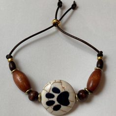 a beaded bracelet with an animal paw print on it