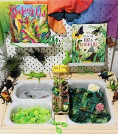 a sink filled with lots of different types of plants and books on top of it