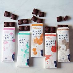 five bars of chocolate sitting next to each other on a white counter top with different flavors