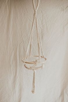 a macrame hanging from a rope on a wall