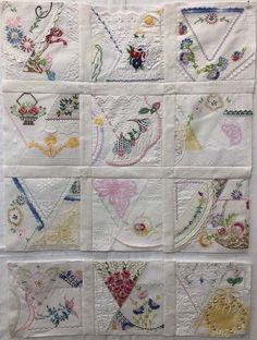 a quilted wall hanging with many different designs on it's sides, including flowers and hearts