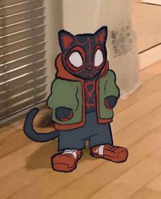 a paper cut out of a cat wearing a hoodie and jacket, standing on the floor