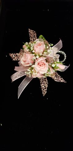 a bridal bouquet with pink roses and baby's breath on a black background