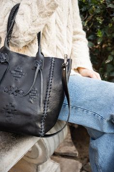 Carry your essentials in this handcrafted premium vegetable tanned leather bag, made by artisans in Buenos Aires. The unique braided design on the front with the drawing of the guarda pampa its a symbol of the southern region of Argentina associated with rural gaucho traditions. It’s the pefect accessory that goes with every outfit. • Vegetable tanned leather • Detachable shoulder strap • Interior pocket • A carabiner for your keys • Spacious main compartment • Snap closure • Unique braided deta Traditional Leather Bag With Woven Details, Traditional Woven Leather Bag, Leather Hand-stitched Satchel For Everyday, Artisan Leather Bags With Woven Detail, Black Leather Satchel With Woven Details, Hand-stitched Leather Satchel For Everyday Use, Black Hand Tooled Bags For Everyday Use, Artisan Woven Leather Bags, Everyday Use Hand-stitched Leather Satchel