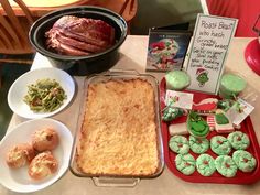 a table topped with lots of food and desserts