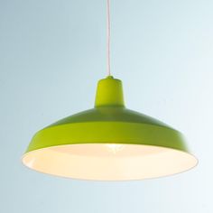 a green and white light hanging from a ceiling