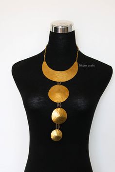 African Brass necklace, Brass jewelry, African jewelry for women, Tribal necklace, One size fits all, Christmas Gift for her, Moms gift The necklace is handcrafted using brass metal. Length: 14 inches Shipping fee is for the first item only, additional items ship for FREE. DHL Express shipping with 3-5 days delivery. To view our brass collection, click here: https://www.etsy.com/shop/NkoroiCrafts?ref=simple-shop-header-name&listing_id=1295061994&section_id=39639351 *Care instructions* Brass tarn Long Gold Necklace With Unique Variations, Round Brass Choker Gift, Round Brass Choker For Gift, Gold Round Pendant Necklace With Unique Variations, Handmade Gold Bib Necklace, Metal Bib Necklace With Adjustable Chain As Gift, Handmade Gold Long Bib Necklace, Gold Long Necklace With Unique Variations, Unique Metal Necklace As Gift