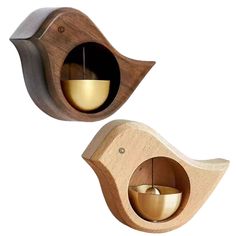 two wooden bird shaped candle holders with candles in them, one is lit and the other is empty