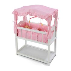 a pink and white baby crib with a canopy over it's top,