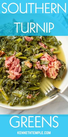 a white bowl filled with greens and ham on top of a blue plate next to a fork