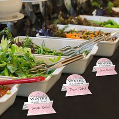 a table topped with lots of different types of salads