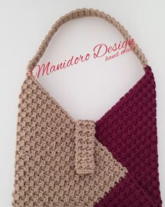 a crocheted purse with a bow on the front and side, sitting on a white surface