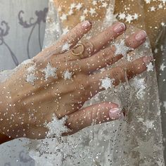 a woman's hand with white glitter on it