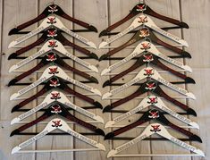 a bunch of knives that are sitting on a wooden table with ribbons in the shape of arrows