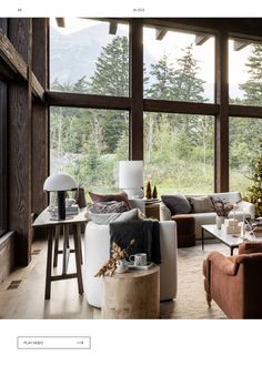 a living room filled with lots of furniture next to a large window covered in windows