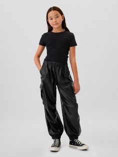 Smooth cotton parachute pants.  Elasticized waist with drawstring.  Front slant pockets.  Back welt pockets.  Side cargo pockets.  Snaps at elasticized leg openings for cinched or wide leg look.  Easy, pull-on waist.  Easy through the hip and thigh. Cheap Trendy Black Joggers, Cheap Fitted Black Joggers, Black Joggers Athleta, Black Nike Joggers Woman, Cargo Parachute Pants, Parachute Trousers, Leather Joggers, Toddler Jeans, Black Cargo Pants