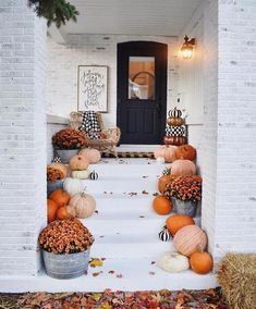 pumpkins and gourds are sitting on the steps