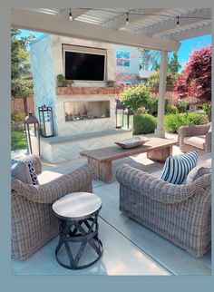 an outdoor living area with wicker furniture and a flat screen tv mounted on the wall