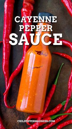 a bottle of cayenne pepper sauce surrounded by chili peppers