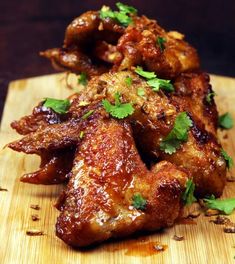 chicken wings with cilantro and parsley on a cutting board, ready to be eaten