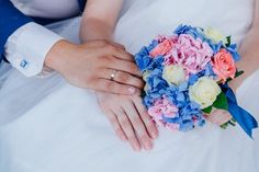 the bride and groom are holding each other's hands