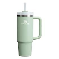 a green coffee cup with a straw in the lid and handle is shown against a white background