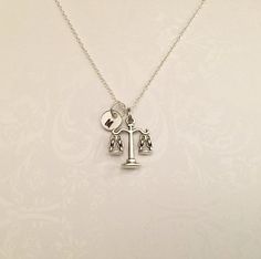 "Scales of Justice Necklace with Initial! Perfect gift for Attorneys, Judges, Law Students, Lawyers, Criminal Attorneys, Paralegals, or Legal Assistants! Very simplistic and elegant necklace that makes statements on many levels. Includes: ●Scale of Justice Pendant- Measurements: 22 x 17mm (appr. 0.85 x 0.65 inch) ●Charm is Antique Silver Plated and made from a zinc alloy metal which is lead and nickel free. ●Initial circles are stamped with letter you choose. Size is 3/8\" Aluminum, 20 gauge ●St Firebird Chronicles, Lawyer Jewelry, Scale Of Justice, Legal Assistant, Law Students, Scales Of Justice, Jewelry Simple, Law Student, Elegant Necklace