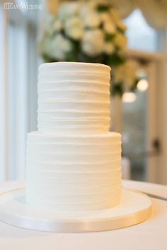 a white wedding cake sitting on top of a table