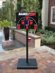 a basketball game set up in front of a fountain with buckets on the side