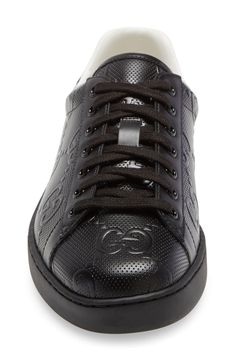 This leather tennis sneaker serves up some heritage style with an interlocking-G logo at the sidewall and a branded heel tab. The sole is embossed with a crest depicting an armored knight surrounded by a rose and a rudder, which symbolize the Gucci family's fervor and entrepreneurship. Style Name:Gucci New Ace Logo Low Top Sneaker (Men). Style Number: 6081028. Black Sporty Gucci High-top Sneakers, Gucci Lace-up Sneakers With Logo Detail, Luxury Black Gucci High-top Sneakers, Gucci Black Lace-up High-top Sneakers, Designer Black Gucci High-top Sneakers, Gucci Sneakers With Logo Detail For Sports, Classic Custom Sneakers With Embossed Logo For Sports, Gucci Custom Lace-up Sneakers For Sports, Gucci Custom Sneakers For Sports