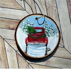 a red truck with christmas trees in the back is painted on a wood slice