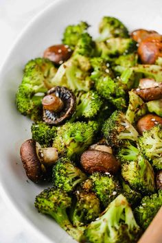 a white bowl filled with broccoli and mushrooms