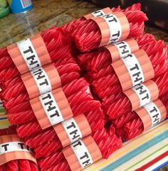 several rolls of red yarn are stacked on top of each other and labeled with the word thrift