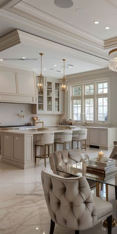 an elegant kitchen and dining room with marble floors, chandelier, cabinets, and chairs