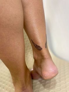 a close up of a person's foot with a tattoo on it