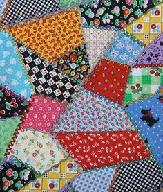 many different colored squares are arranged together on the table top, with black and white polka dots