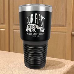 a black and silver cup sitting on top of a counter