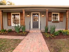 a small house with brick walkway leading to the front door