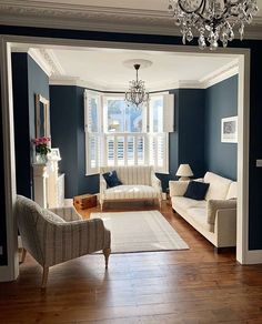 a living room filled with furniture and a chandelier