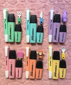 several different types of toothbrushes are lined up on a pink towel next to each other