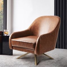 a brown leather chair sitting on top of a carpeted floor next to a window