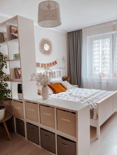 a bedroom with a bed, bookcases and shelves on the wall above it