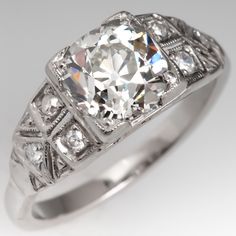 The vintage ring is centered with one (1) old European cut diamond set into a four-prong head. The shoulders feature a pierced design are each accented with three (3), bead set, round single cut diamonds, bordered with milgrain edging. The ring measures 7.2mm at the top, rises 6.0mm above the finger, tapering to 2.1mm wide and 1.6mm thick at the base of the shank. Vintage White Gia Certified Rings, Antique Gia Certified Diamond Ring For Anniversary, Vintage Silver Gia Certified Diamond Ring, Vintage Silver Gia-certified Diamond Ring, Vintage Gia Certified White Gold Diamond Ring, Gia Certified Antique Diamond Ring, Vintage Diamond Ring With Center Stone Cushion Cut, Vintage Cushion Cut Diamond Ring With Single Cut Diamonds, Vintage Cushion Cut Diamond Ring With Center Stone