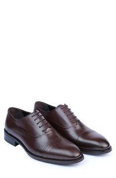 Handmade of smooth leather, this cap-toe dress shoe with a classic oxford silhouette offers a sophisticated, elegant look. Leather upper and lining/synthetic sole Made in Turkey Classic Oxford Lace-up Shoes With Rubber Heel Cap, Classic Cap Toe Business Lace-up Shoes, Semi-formal Cap Toe Oxfords With Branded Insole, Cap Toe Oxford Lace-up Shoes For Business, Business Leather Cap Toe Shoes With Rubber Heel Cap, Business Cap Toe Leather Shoes With Rubber Heel Cap, Cap Toe Oxfords With Goodyear Welt Construction For Business, Cap Toe Dress Shoes With Goodyear Welt For Office, Office Dress Shoes With Goodyear Welt And Cap Toe